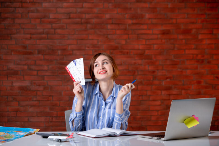 front-view-travel-agent-her-working-place-with-plane-tickets-agency-map-service-global-assistant-world-operator-managers (1)